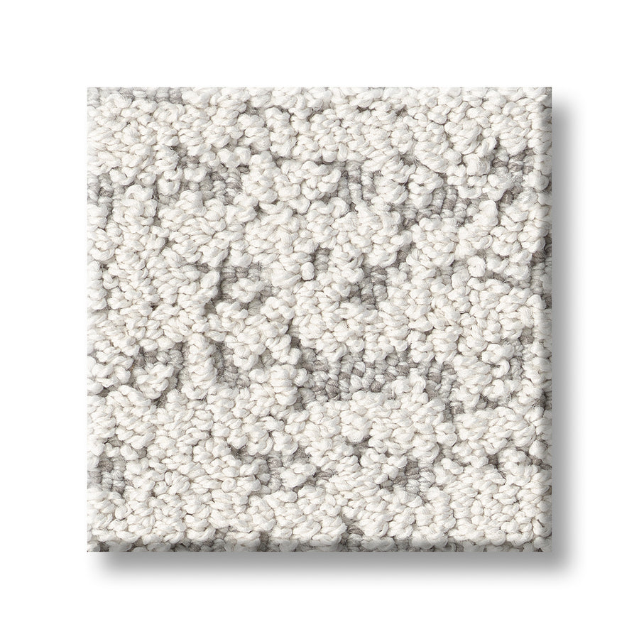 A square sample of Tangent On Trend Carpet, featuring a textured light gray and white loop-pile with a subtle mottled pattern, is displayed on a white background, highlighting its stylish and contemporary design.