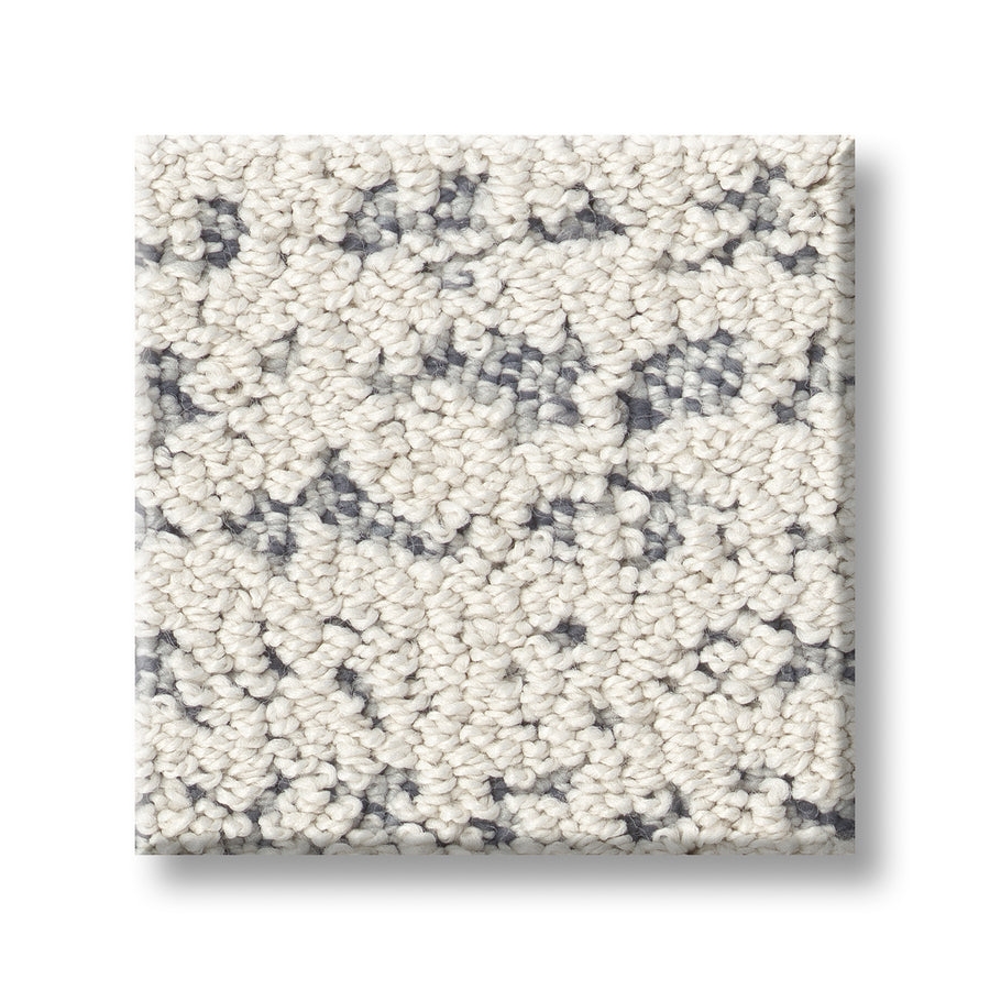 The Tangent On Trend Carpet sample features a square shape, looped texture, cream base, and dark gray speckles. Displayed on a white background, it offers a stylish design ideal for any room.