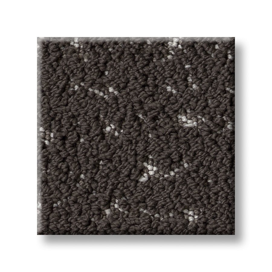 A close-up of the Tangent On Trend Carpet swatch displays its luxurious looped pile with specks of lighter gray and white, emphasizing its modern design on a crisp white background.