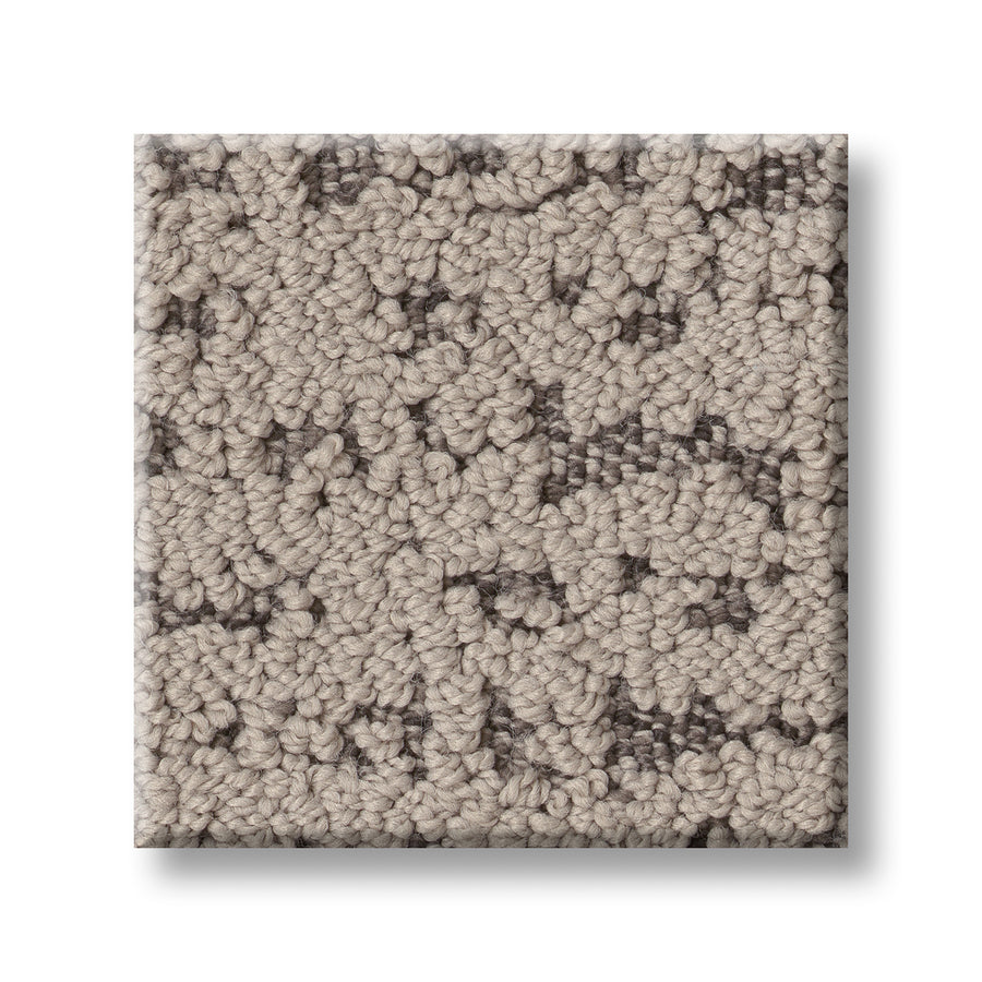 A square sample of Tangent On Trend Carpet in beige and gray, featuring raised loops and subtle speckles for a stylish, luxurious feel.