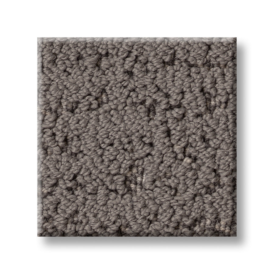 A square sample of Tangent On Trend Carpet in textured, looped gray with a subtle pattern is shown against a white background.