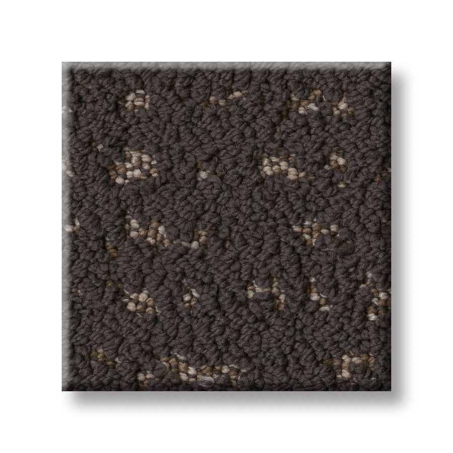 A close-up of Tangent On Trend Carpet in dark gray features a textured loop pattern with light gray and beige flecks, highlighting its luxurious feel and stylish, on-trend design.