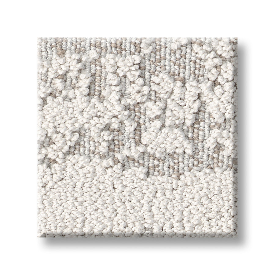 A square sample of Discover On Trend Carpet in light beige and off-white, featuring luxurious looped and cut pile patterns, is displayed on a white background.