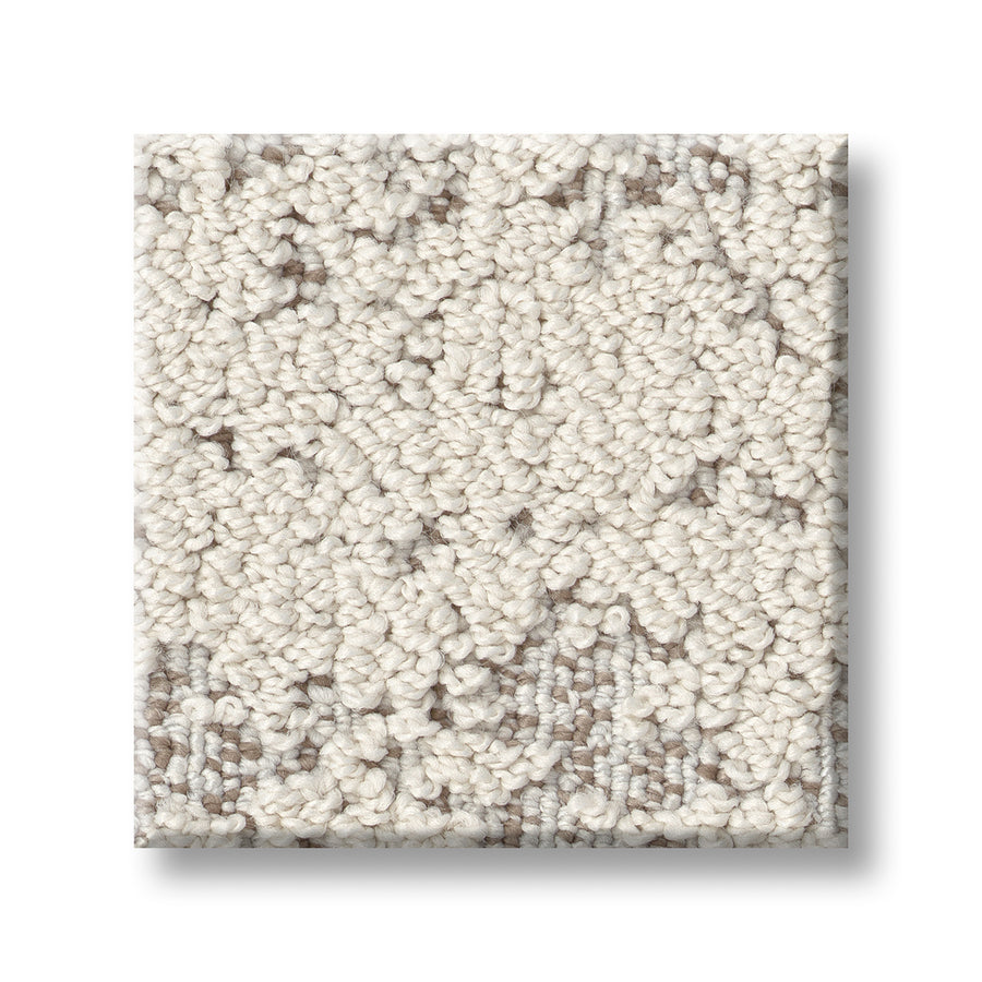 A close-up of Discover On Trend Carpet, showing a square swatch with textured, looped off-white fibers, subtle beige undertones, and a luxurious feel on a white background.
