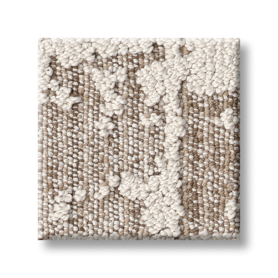 A square sample of Discover On Trend Carpet shows a beige and off-white abstract pattern with raised, looped threads and a mix of smooth and nubby textures—ideal for luxury or contemporary interiors.