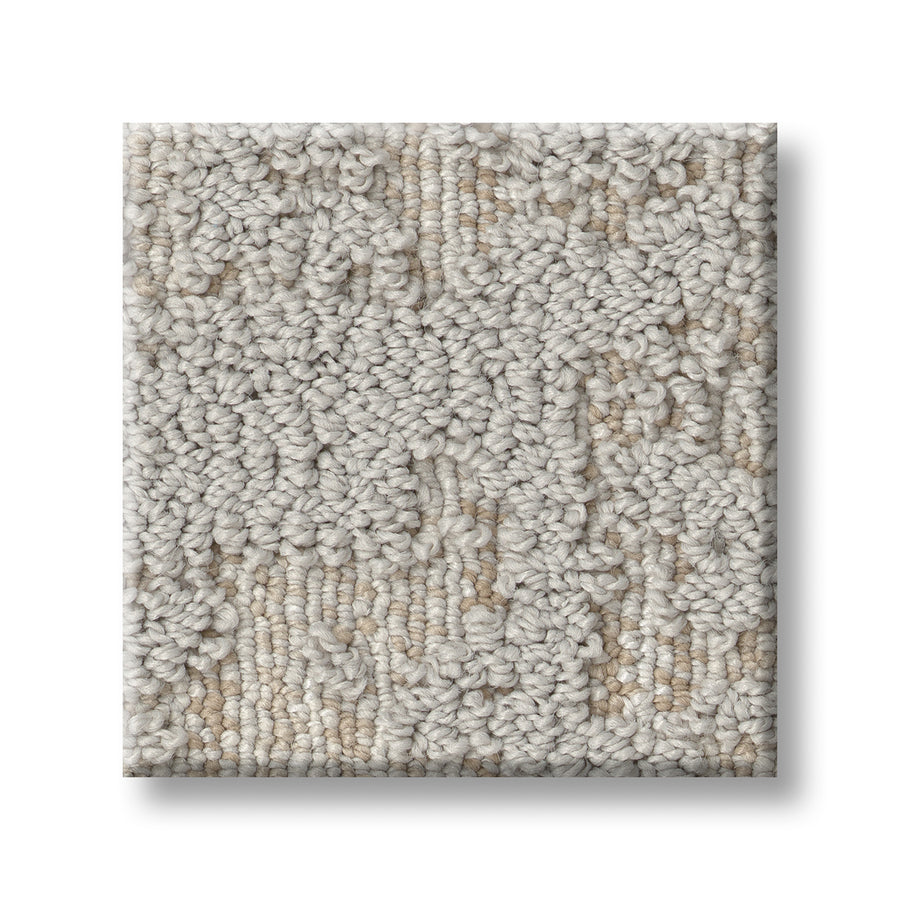 A square sample of Discover On Trend Carpet in light beige, featuring a textured looped pile with subtle color variations and a contemporary raised design on a white background.