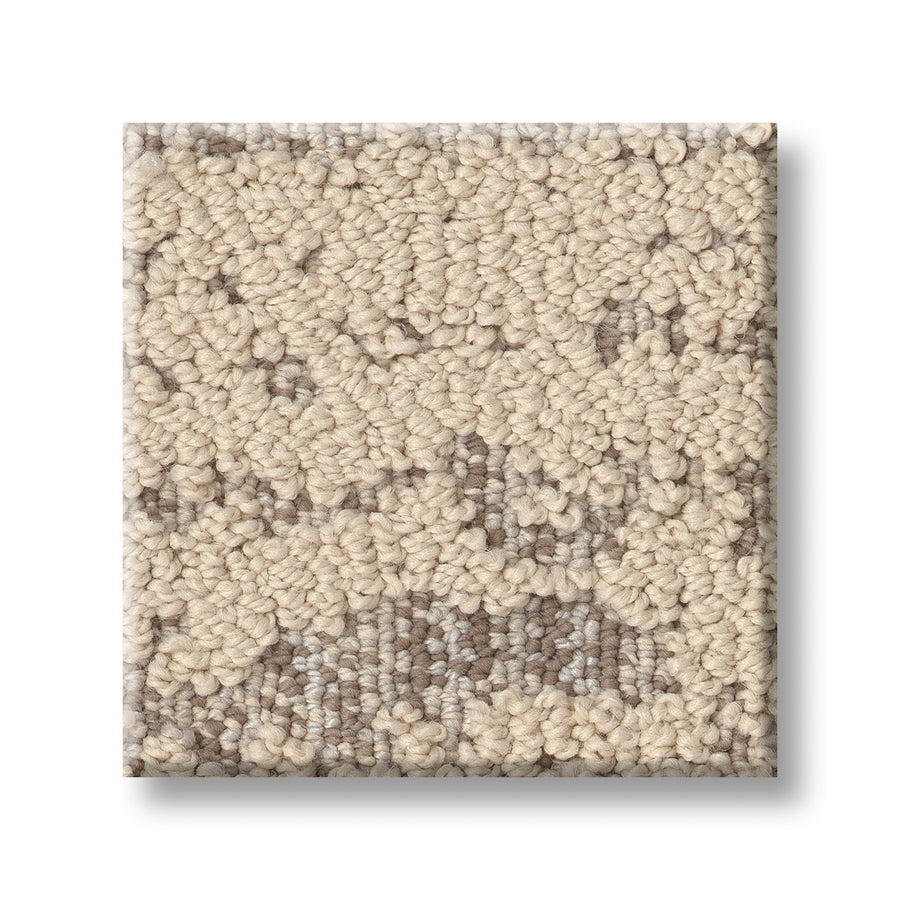 A square sample of Discover On Trend Carpet displays a looped pile in beige and light brown, with a subtle abstract pattern on a white background—showcasing contemporary style ideal for modern interiors.