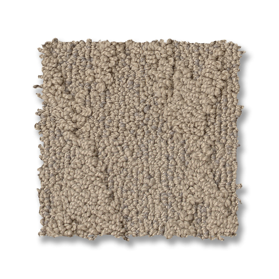 A square swatch of Illumination On Trend Carpet, featuring textured looped beige fibers, is shown against a white background.