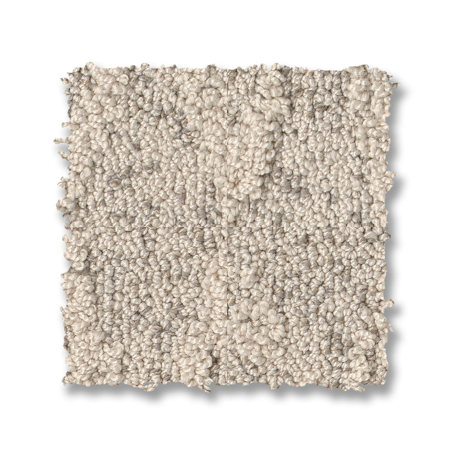 A square sample of Illumination On Trend Carpet, a textured loop-pile beige carpet with subtle light and dark variations, displayed on a white background.