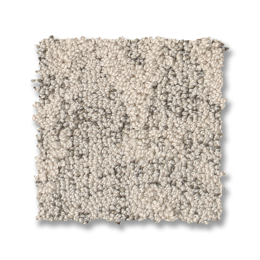 A square swatch of Illumination On Trend Carpet in light beige with subtle gray speckles and a textured, looped finish, shown on a white background.
