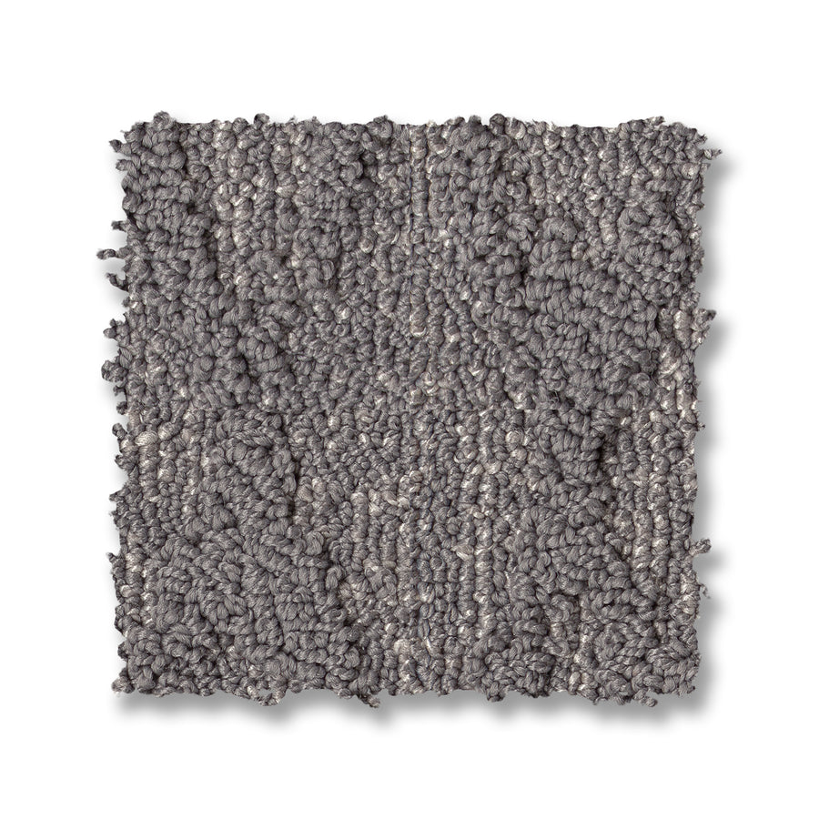 A square sample of Illumination On Trend Carpet in looped gray, with a textured and slightly uneven surface, is displayed against a white background.