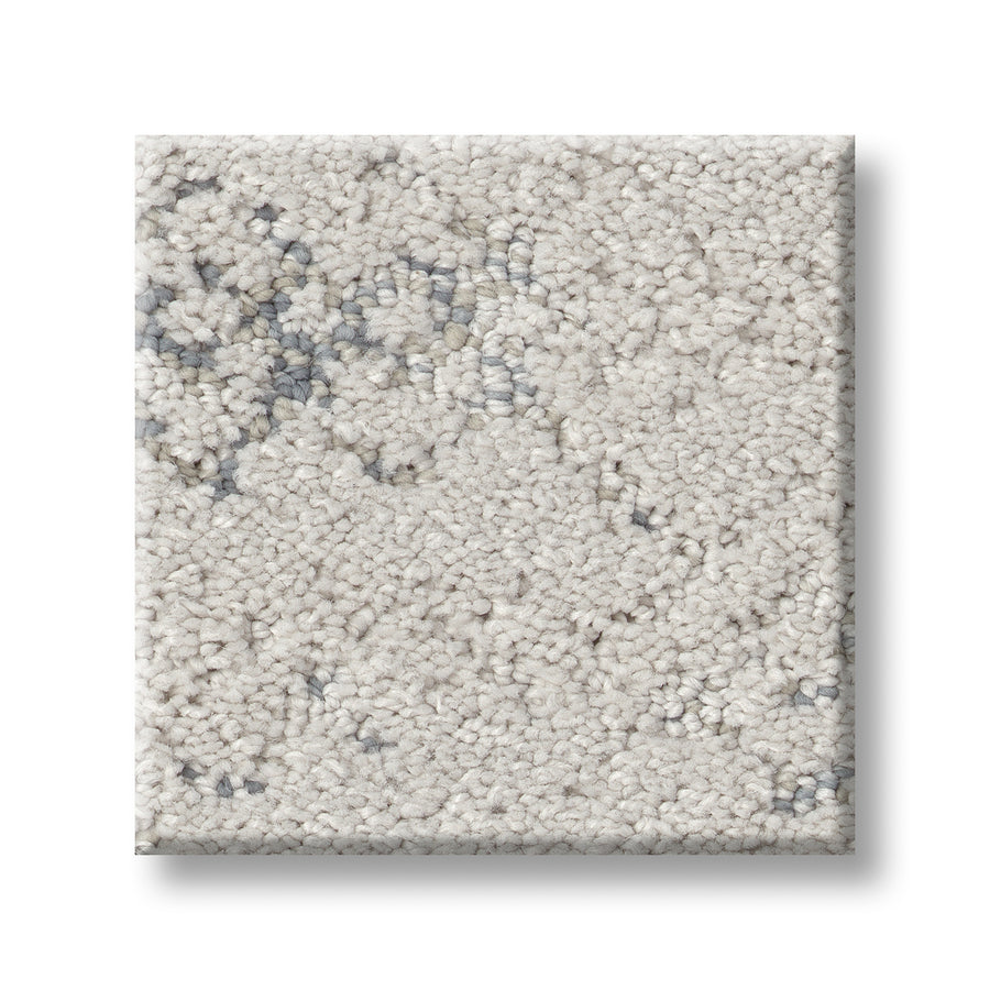 A square sample of Evoke On Trend Carpet in light gray, featuring subtle dark gray and blue speckles, is shown on a white background.