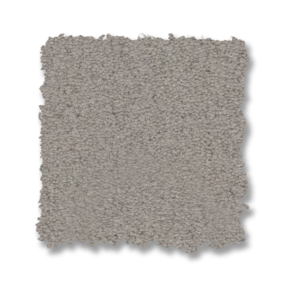 A square sample of Finery Pet Friendly Carpet in light gray is shown on a white background. Its tightly looped, textured fibers and uneven edges highlight its soft feel while ensuring durable, pet-friendly performance.