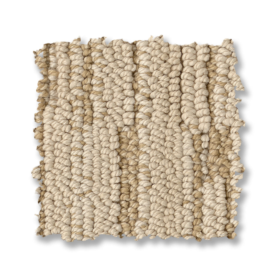 A close-up of a square swatch of Loom Berber Carpet shows its beige textured loop-pile with mixed light and darker beige fibers, displayed on a white background for a sophisticated look.