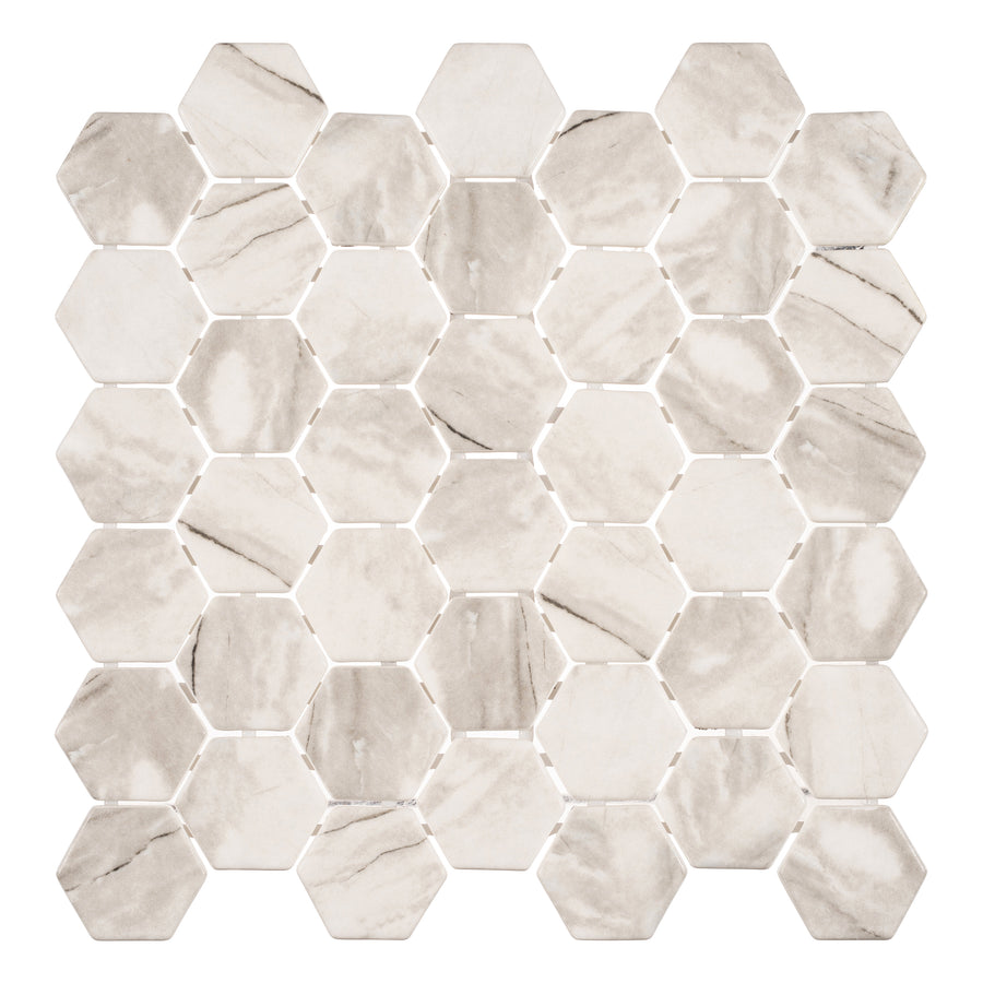 Mayan Garden Hexagon Glass Mosaic Tile in Aztec Gray features hexagonal tiles with subtle veining and natural variations, arranged in a grid pattern reminiscent of refined Mayan designs, displayed against a white background.