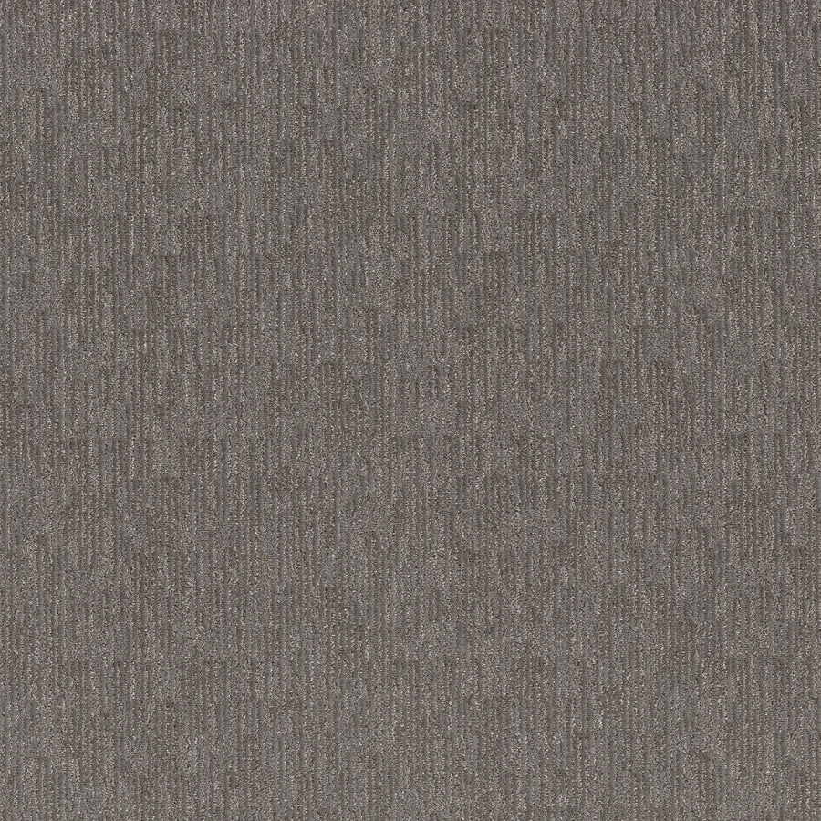 Close-up of Sneak Peak Berber Carpet in Magnetic, showing its textured gray surface with vertical stripes. The dense pile and blend of light and dark fibers offer a subtle, uniform look, perfect for durable flooring.