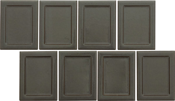 Eight Marco and Polo 4x5 Glossy Porcelain Tiles in Marco Coal are arranged in two rows, with the bottom left tile offset, each featuring a subtle inner rectangular border for a refined, designer-inspired look.