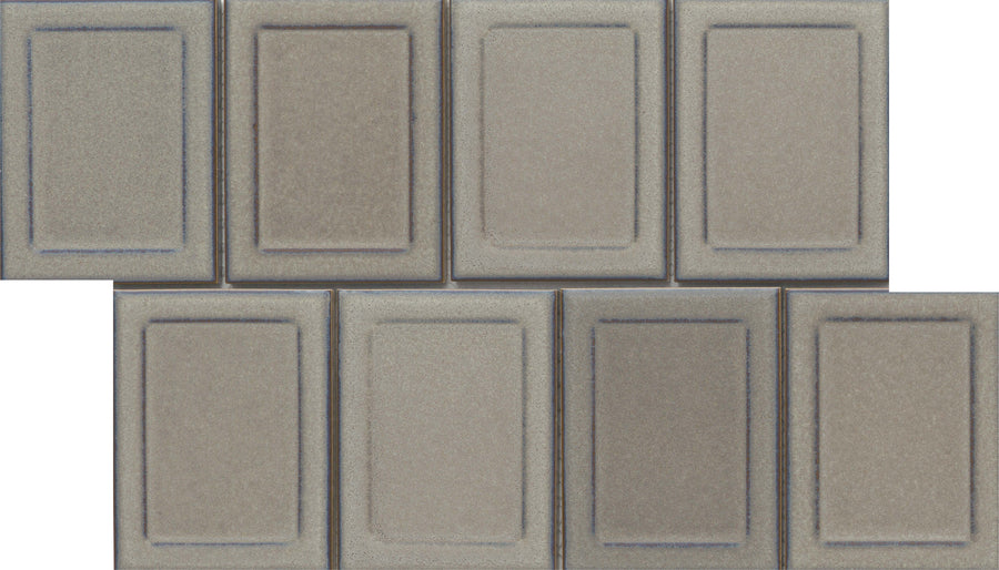 Eight Marco and Polo 4x5 Glossy Porcelain Tiles in Marco Tawny, with a framed profile and raised borders, are arranged in two staggered rows of four, creating a brick-like designer-inspired look.