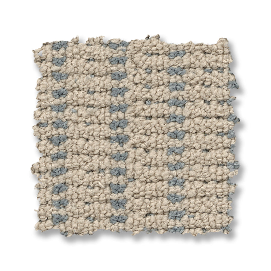 A square swatch of Laken On Trend Carpet, with a beige and light blue grid pattern and textured woven finish, is shown with slightly frayed edges against a white background.