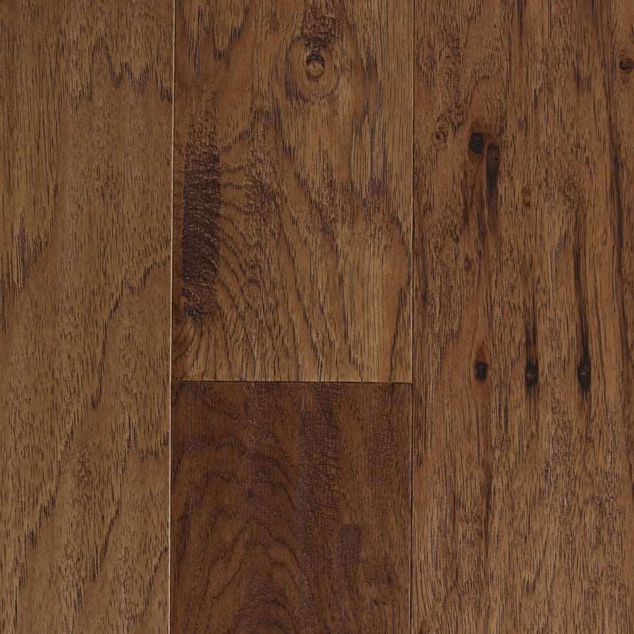 Close-up of Deepwood Trail 5" Hickory Oak Hardwood floor planks in the Mariposa color, featuring a natural finish that highlights distinct wood grain patterns and knots in various shades of brown. The engineered hardwood surface appears smooth and well-maintained, exemplifying premium hardwood flooring quality.
