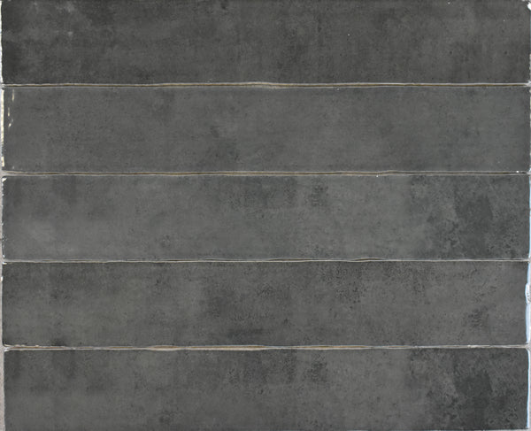 A close-up of a wall showcases the textured surface of Marrakesh 2x16 Ceramic Tile.