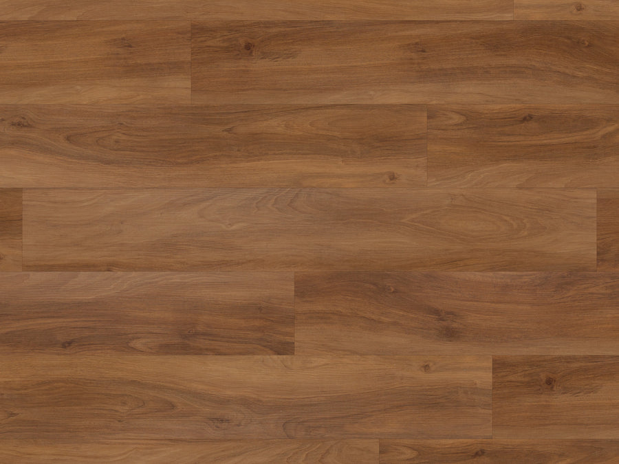 Korlok Reserve 7" Vinyl Plank in Marron Elm features a natural, medium-brown finish with visible grain patterns. Its scratch-resistant vinyl planks show subtle shade and texture variations for a warm, rustic appeal.