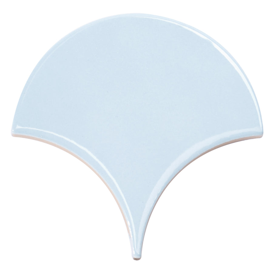 The Tidal 2x5 Ceramic Tile features a glossy light blue finish and a unique fan-shaped scallop design with smooth curves and a pointed bottom—an elegant choice for adding luxury to any space.