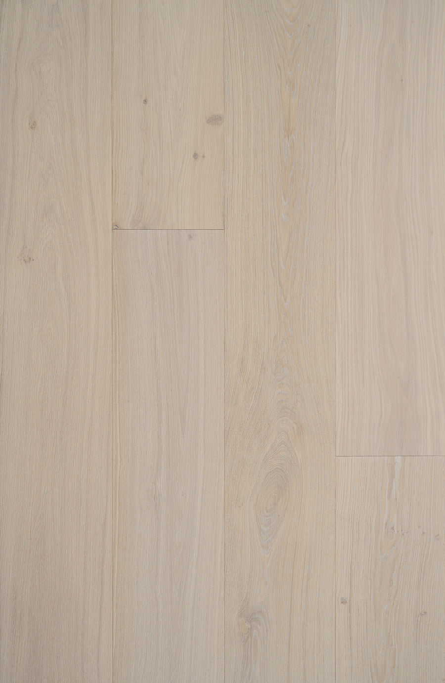 Tribeca Loft French Oak 9.4" Hardwood in McCarren features light-colored, wide planks with visible grain and subtle knots, arranged side by side for a smooth, natural look.