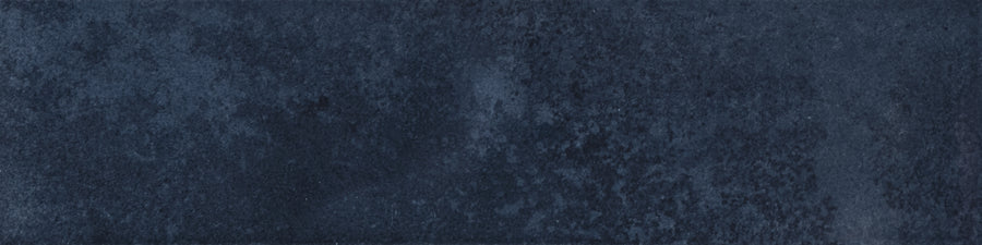 Menagerie 2.5x9.5 Porcelain Tile features a textured surface in varying shades of dark blue, with subtle mottled patterns and hints of handmade detail for a unique, artisan-inspired look.