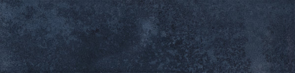 Menagerie 2.5x9.5 Porcelain Tile features a textured surface in varying shades of dark blue, with subtle mottled patterns and hints of handmade detail for a unique, artisan-inspired look.
