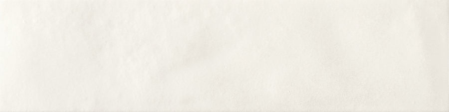 The Menagerie 2.5x9.5 Porcelain Tile features a plain, off-white textured surface with subtle shading variations, evoking the look of handcrafted paper or a smoothly plastered wall.