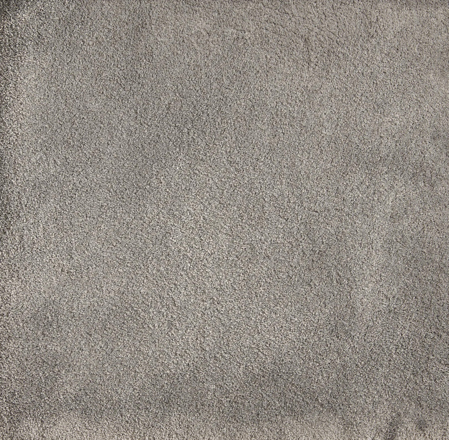 A close-up of Cha Cha On Trend Carpet in Metal shows its textured, light gray surface with visible fibers—ideal for high-traffic areas and perfect for adding contemporary style to any space.