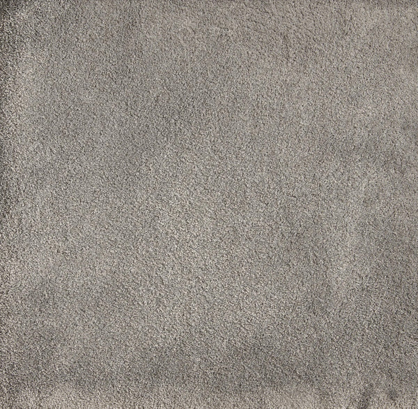 A close-up of Cha Cha On Trend Carpet in Metal shows its textured, light gray surface with visible fibers—ideal for high-traffic areas and perfect for adding contemporary style to any space.