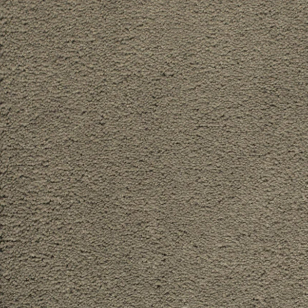 A close-up of the rough, textured grayish-brown Meteor color in Dolce Family Friendly Carpet, designed for high-traffic areas where durability and comfort are essential.