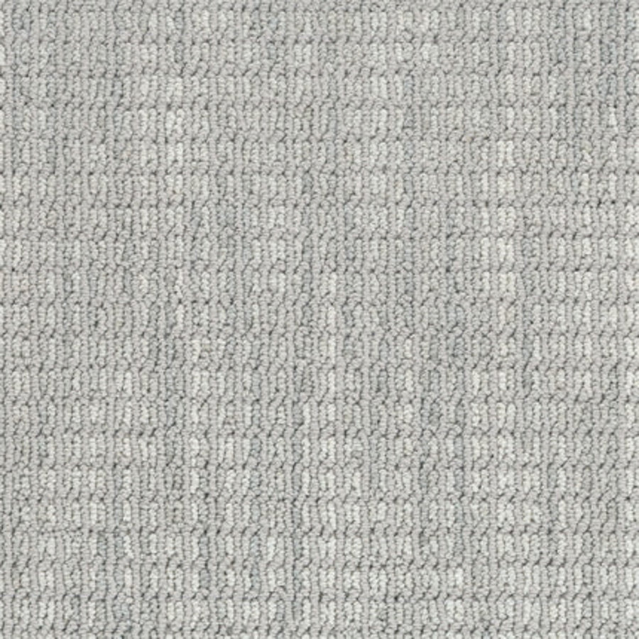 Close-up of Haven Berber Carpet in Mist, a light gray, durable carpet featuring a subtle, repeating textured pattern of small rectangular loops for a soft yet structured look.