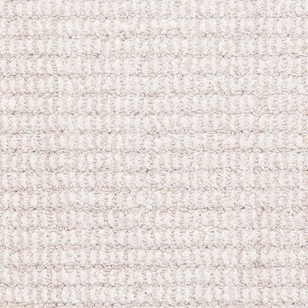 Close-up of Aspen Berber Carpet in Mist, featuring a looped pile with a grid-like pattern. The surface is soft and uniform, highlighting its textured, woven fibers and regular repeating design.