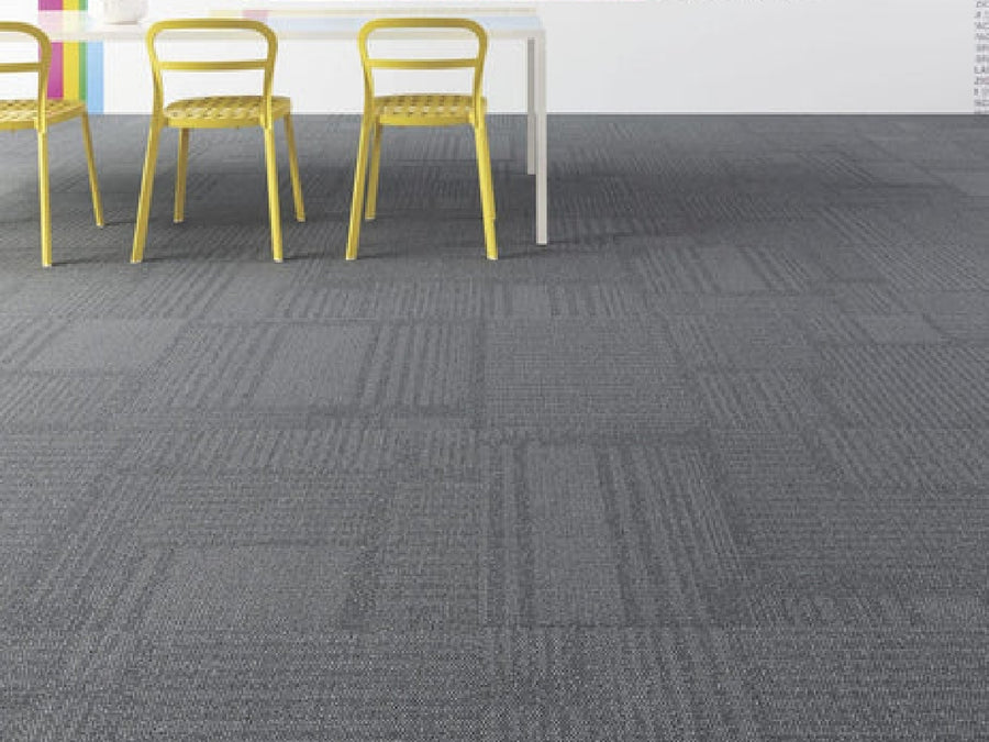 Three yellow chairs surround a white table on Commercial Modular Carpet Tiles with a gray pattern, ideal for stylish commercial spaces. The background wall has subtle pastel stripes on the left side.