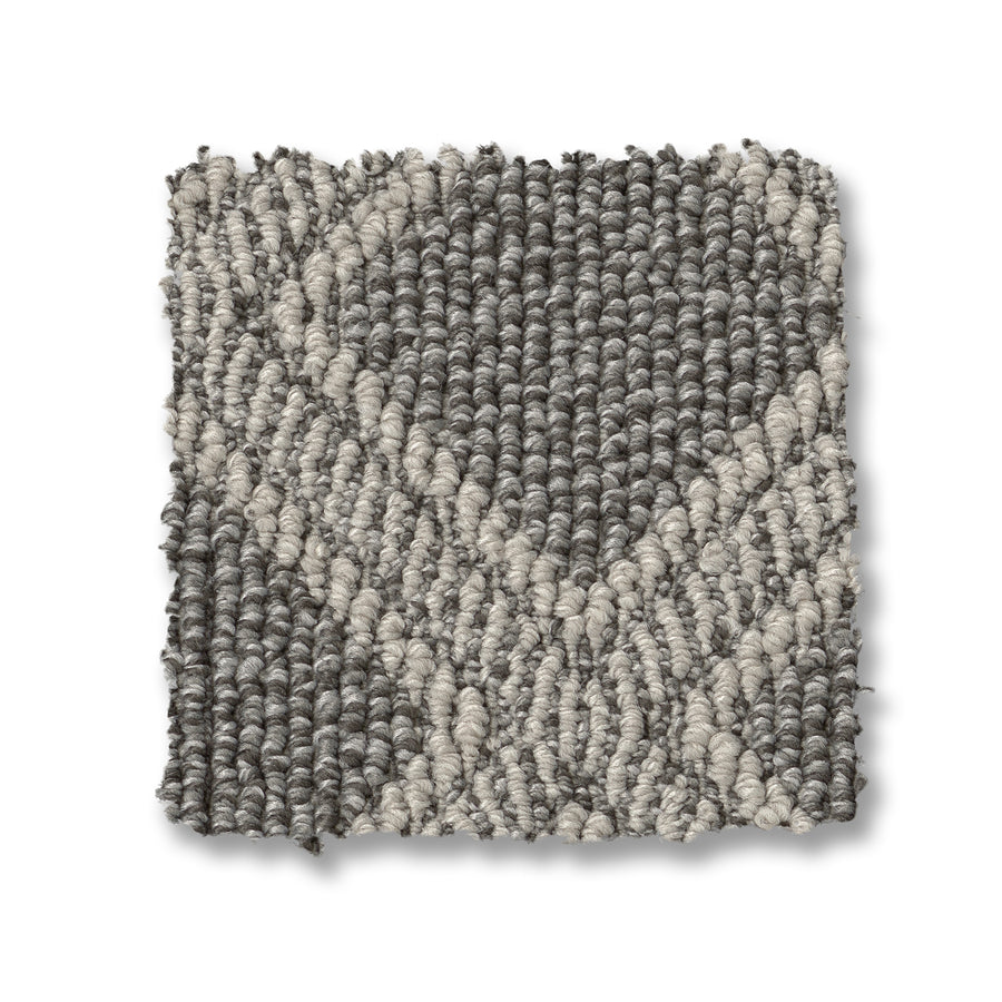 The Scout Pet Friendly Carpet features a durable, square swatch with a gray base and cream geometric, intersecting lines for a modern diamond pattern that's both stylish and pet friendly.