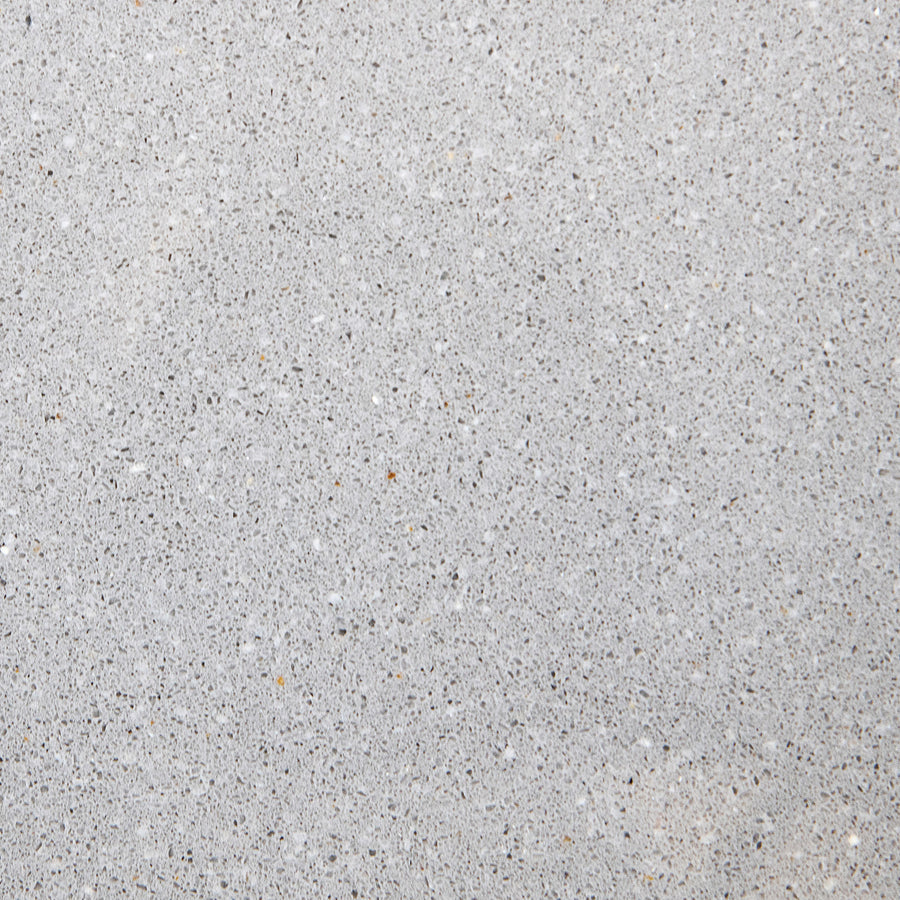 Close-up of the Marble Sill 6x72 in Morning Fog, featuring a smooth, light gray surface with specks and subtle texture, reminiscent of marble with a honed edge.