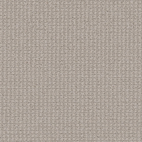 A close-up of the Mykonos Berber Carpet in Bay Dream highlights its tightly looped berber weave, creating a subtle grid pattern and bringing a luxurious look to any room.