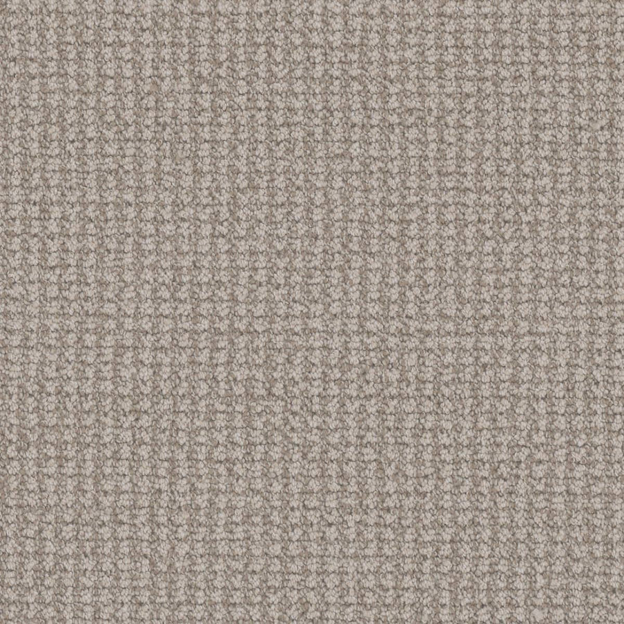 Close-up view of the Mykonos Berber Carpet in Capri, showcasing its soft, textured beige surface with a tight, grid-like berber weave for a uniform and luxurious finish.