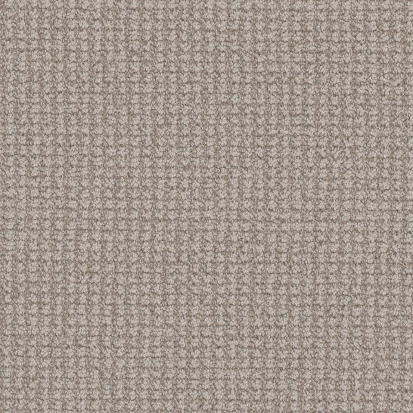 Close-up view of the Mykonos Berber Carpet in Capri, showcasing its soft, textured beige surface with a tight, grid-like berber weave for a uniform and luxurious finish.