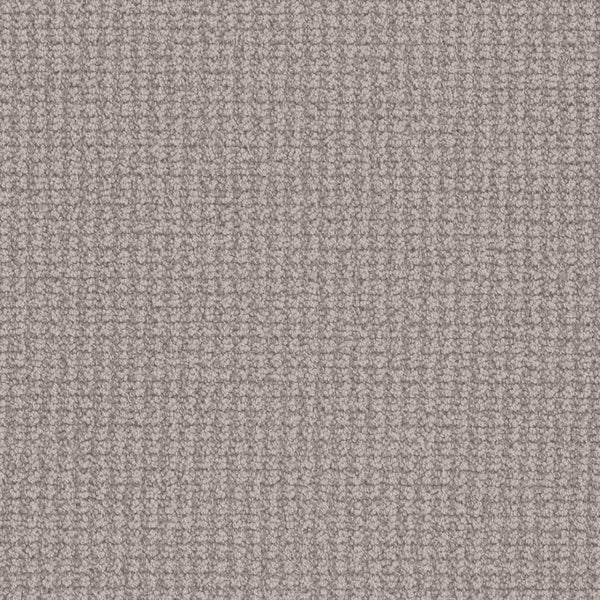 Close-up of the Mykonos Berber Carpet in Riviera, highlighting its soft, textured surface and grid-like berber weave. Tightly packed loops offer even lighting and showcase the luxurious quality of this premium flooring.