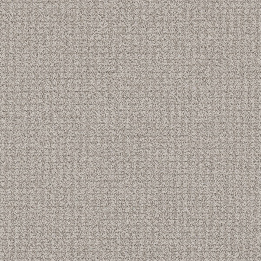 Close-up view of the Mykonos Berber Carpet in Serene color, featuring a tightly looped berber weave. Its soft, evenly toned surface displays subtle shadows that highlight the luxurious texture of this premium flooring.