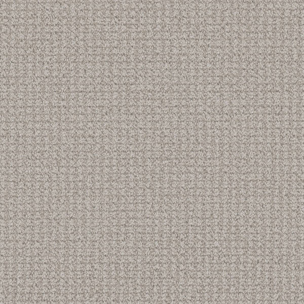 Close-up view of the Mykonos Berber Carpet in Serene color, featuring a tightly looped berber weave. Its soft, evenly toned surface displays subtle shadows that highlight the luxurious texture of this premium flooring.