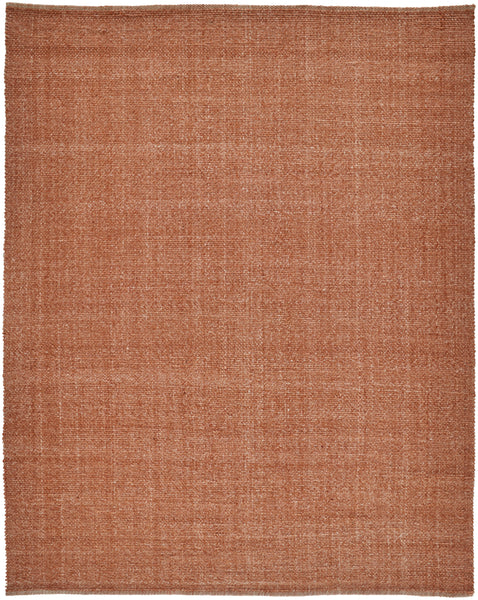 The Naples Area Rug, a large square piece in warm terracotta, features a subtle woven pattern and slightly uneven edges for an elegant accent in any room.