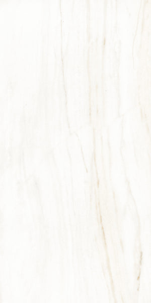 A close-up of a white marble surface with subtle beige and light gray veining running vertically, creating a natural, elegant pattern. The texture appears smooth and polished.