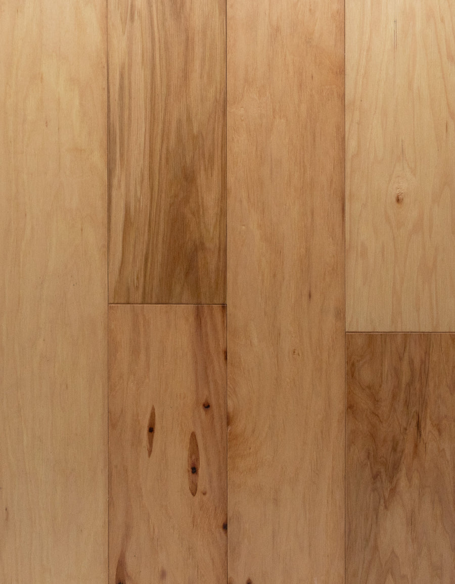 Deepwood Trail 5" Hickory Oak Hardwood in Natural features light brown engineered planks with pronounced grain patterns and knots. The large rectangular boards are arranged side by side, showcasing authentic color and texture variations for an elegant, natural appearance.