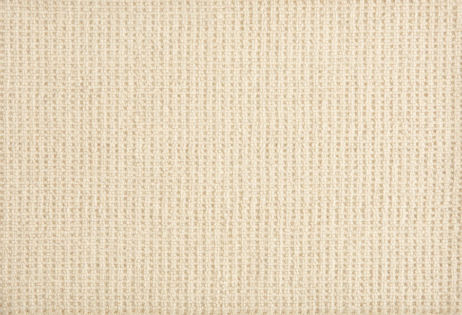 Close-up of Martina Berber Carpet in Natural, showing a beige, textured woven grid pattern. The soft, uniform surface has subtle thread variations—ideal for contemporary spaces or high-traffic areas needing lasting style.