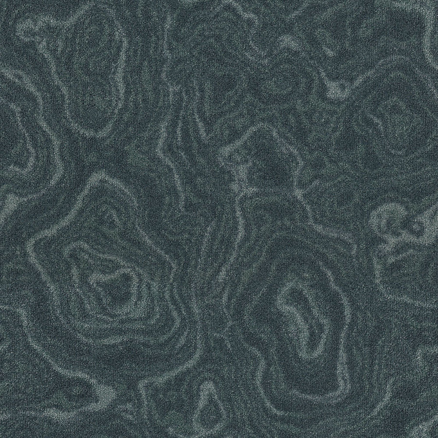 Nature's Gem On Trend Carpet features a dark green malachite-inspired texture with swirling, layered patterns and organic wavy lines, creating a natural marbled look—ideal for adding vibrant color to any space.